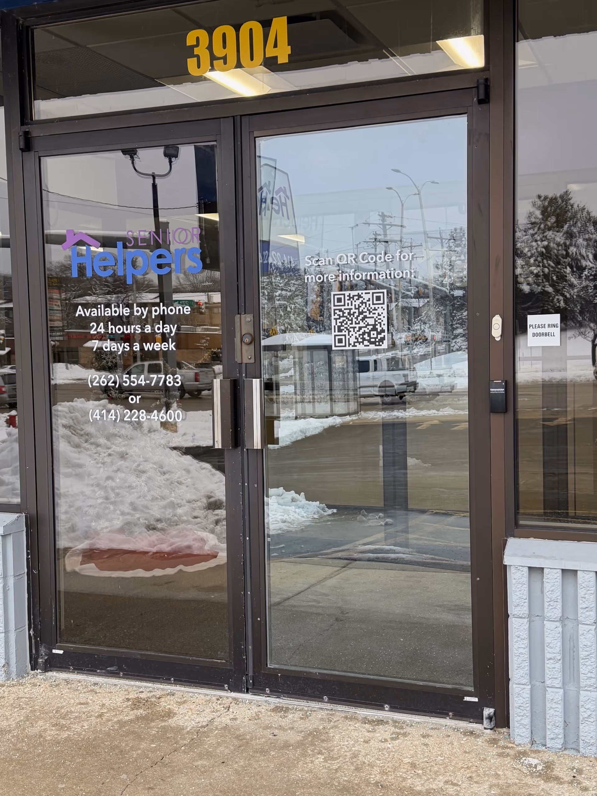 Glass entrance doors of Senior Helpers Milwaukee with building number 3904 and a QR code.