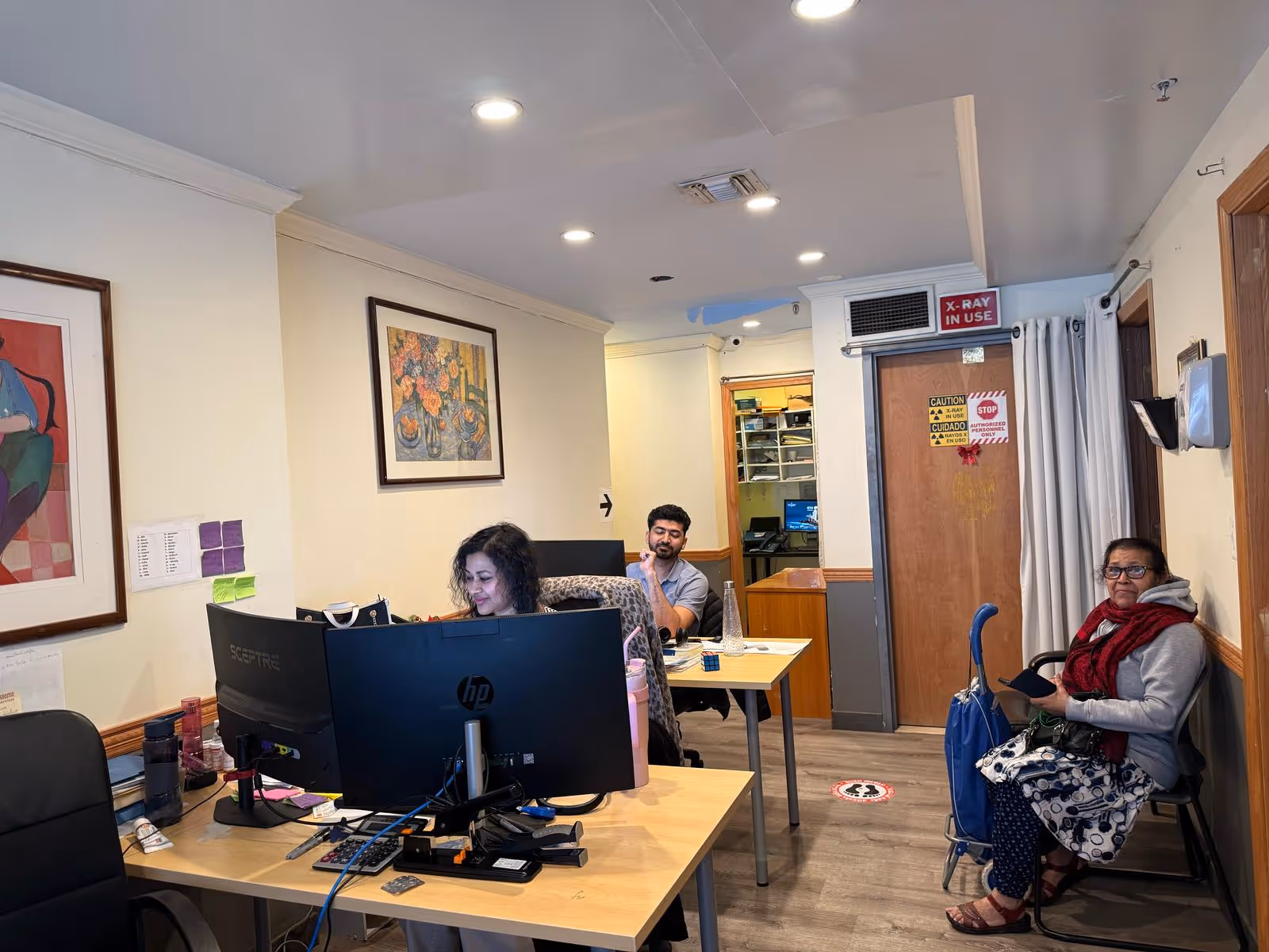Interior office space at Prohealth Home Care Inc Elmhurst Branch with desks, computers, and staff.