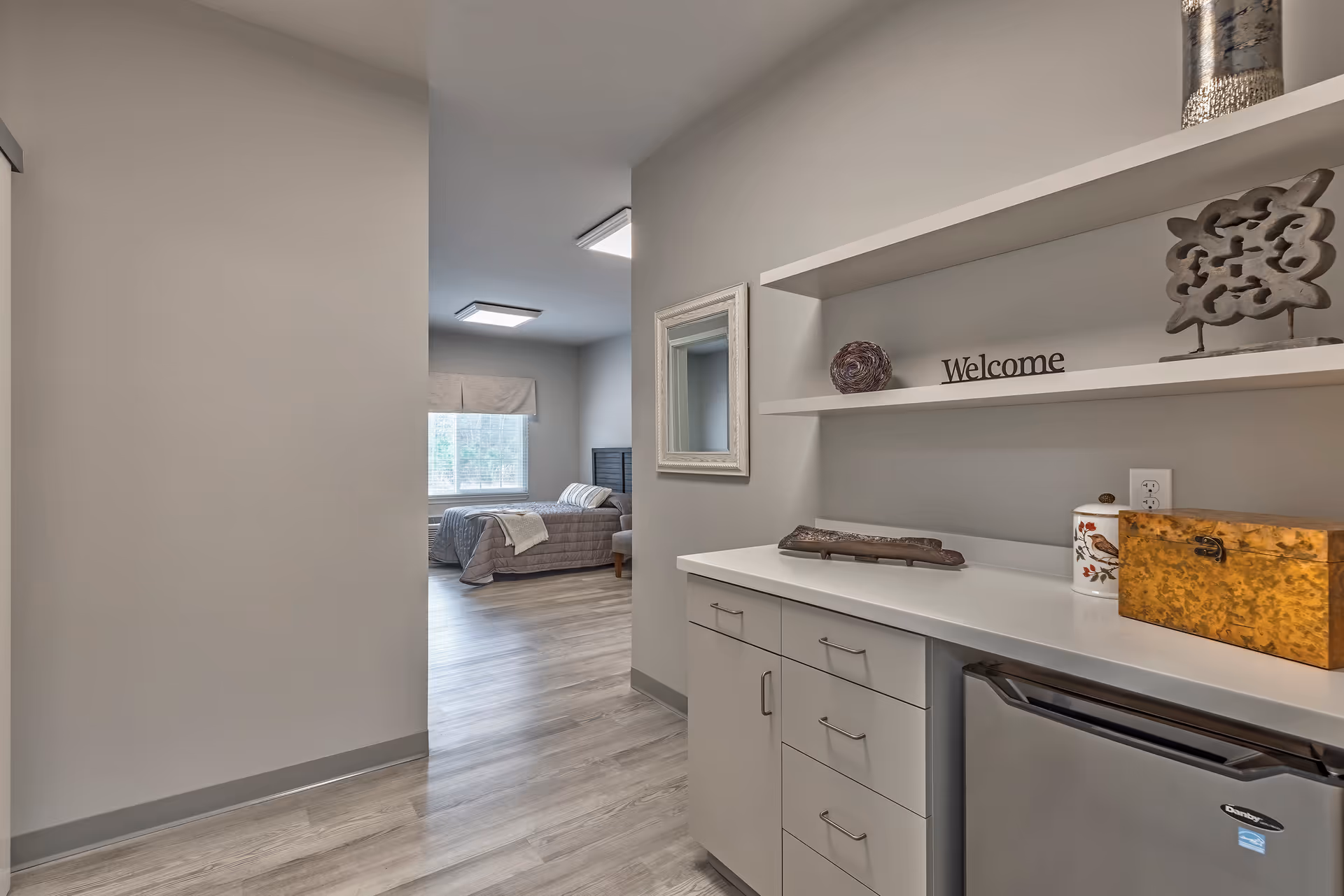 Interior hallway leads to a bedroom with a counter and shelves at The Landings of Swansboro.