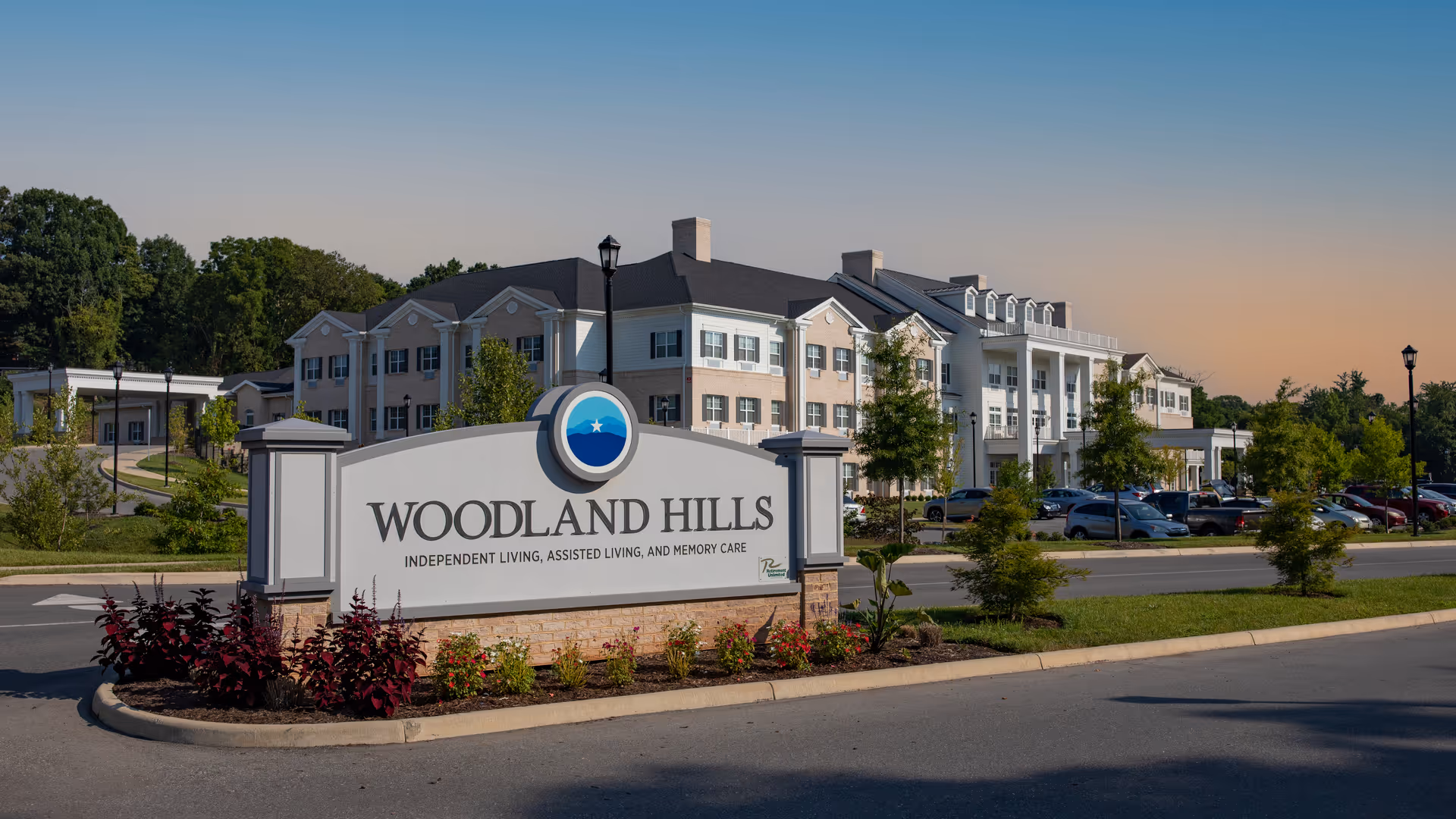 Exterior view of Woodland Hills building with front sign and landscaping.