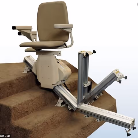 A beige stair lift seat installed on carpeted steps with a metal track in a facility