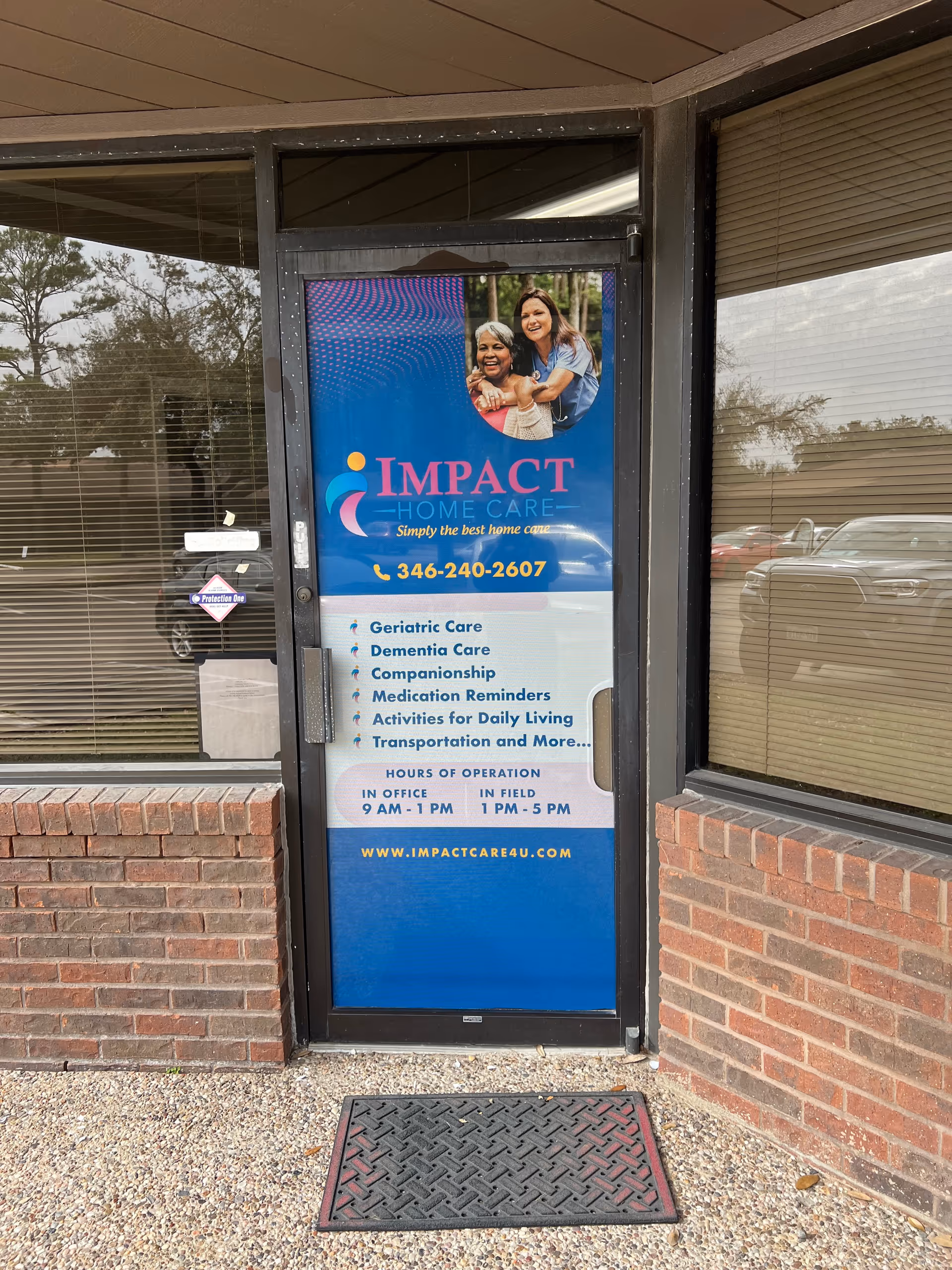 Storefront entrance with a blue Impact Home Care sign on a brick exterior.