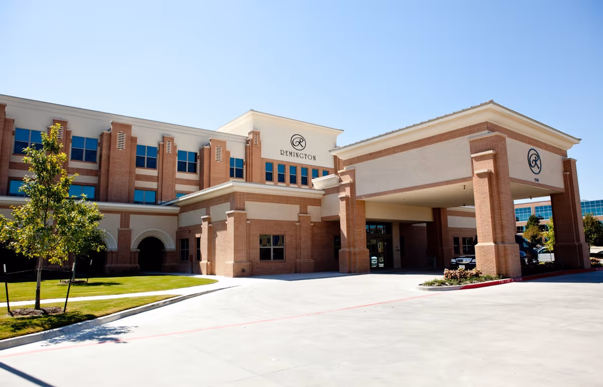 Front view of Remington Transitional Care of Richardson, brick and beige senior care facility.