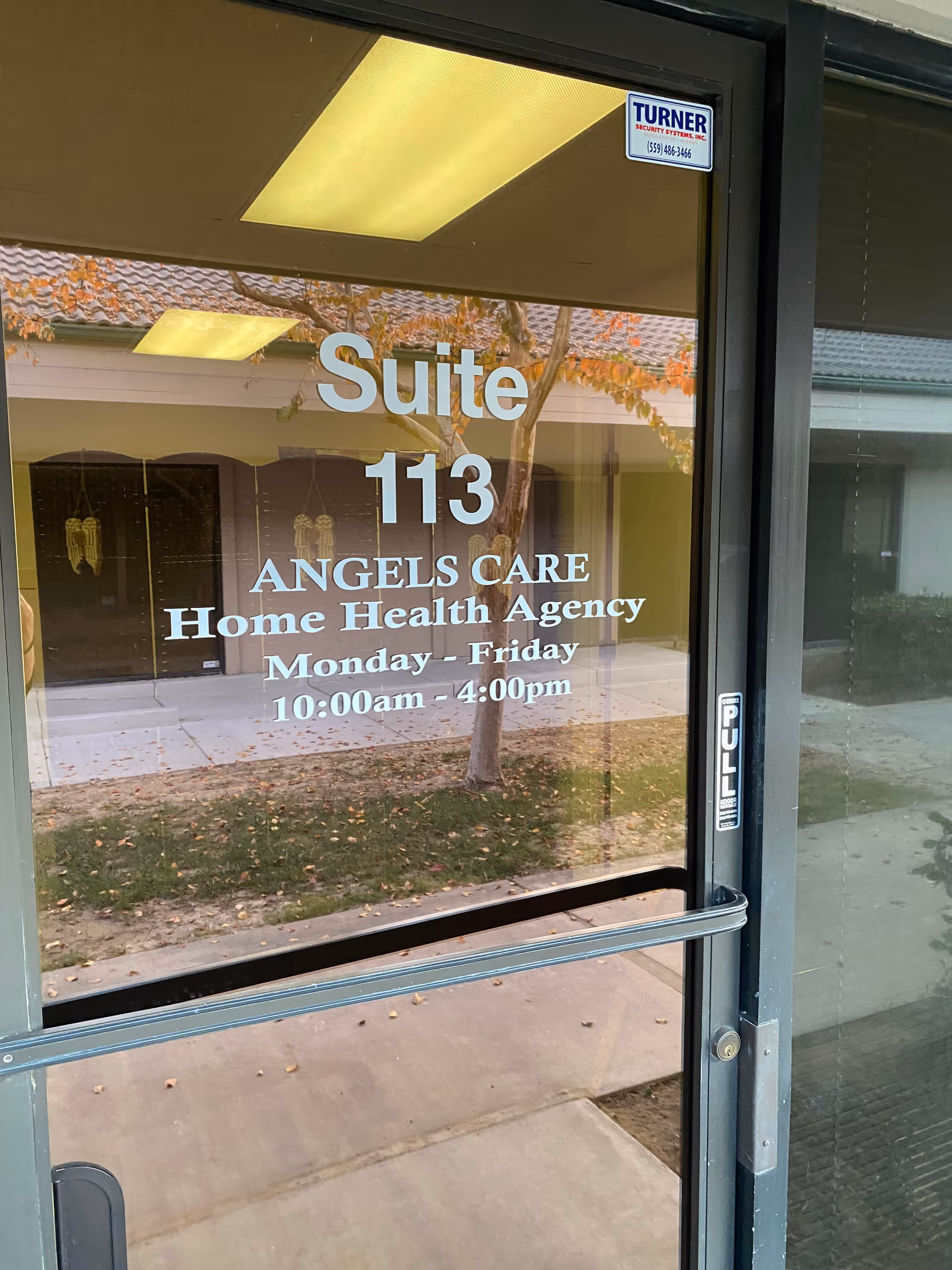 Glass door with Suite 113 and Angels Care Home Health Agency signage.