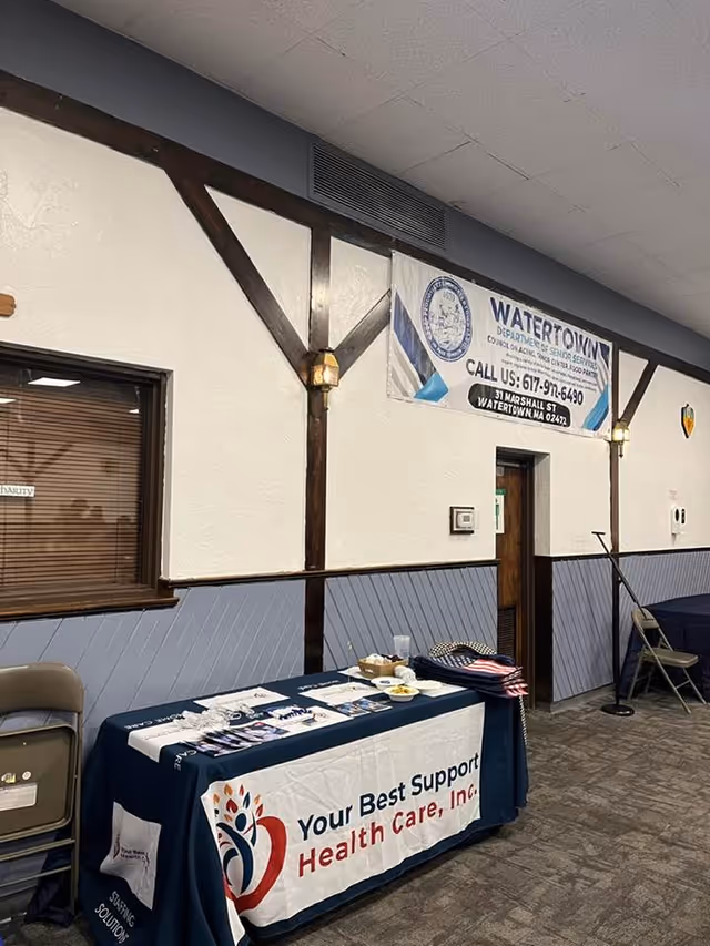 Indoor hall with a promotional table for Your Best Support Health Care, Inc.