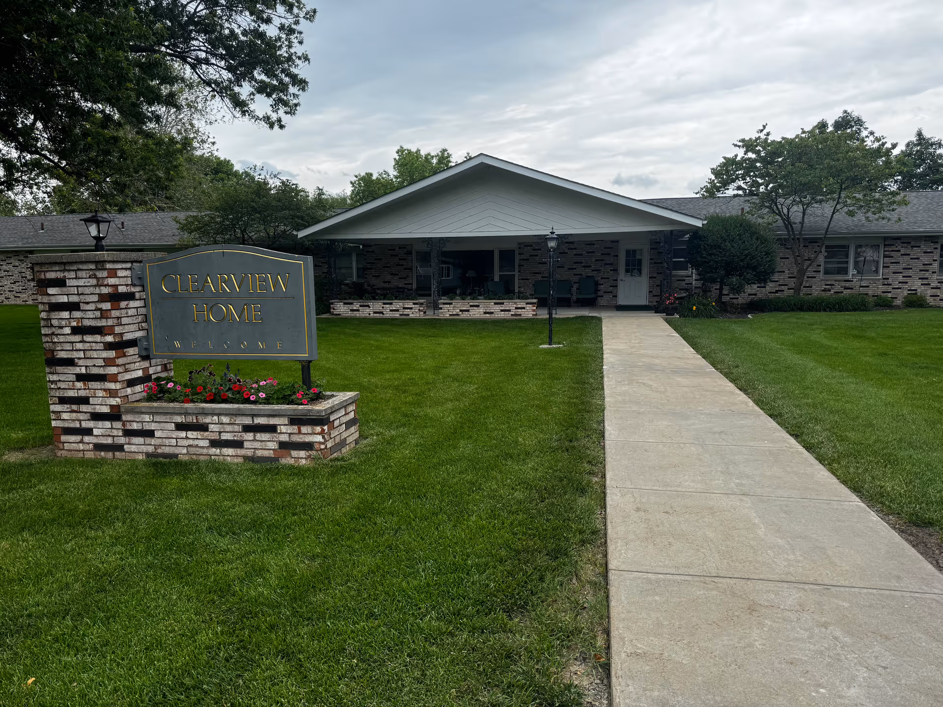 Brick building with a covered entrance and a stone sign reading Clearview Home.