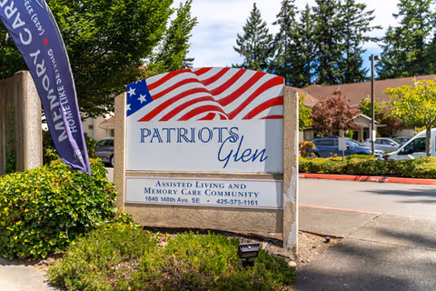 Front sign for Patriots Glen Assisted Living and Memory Care Community with landscaped surroundings.