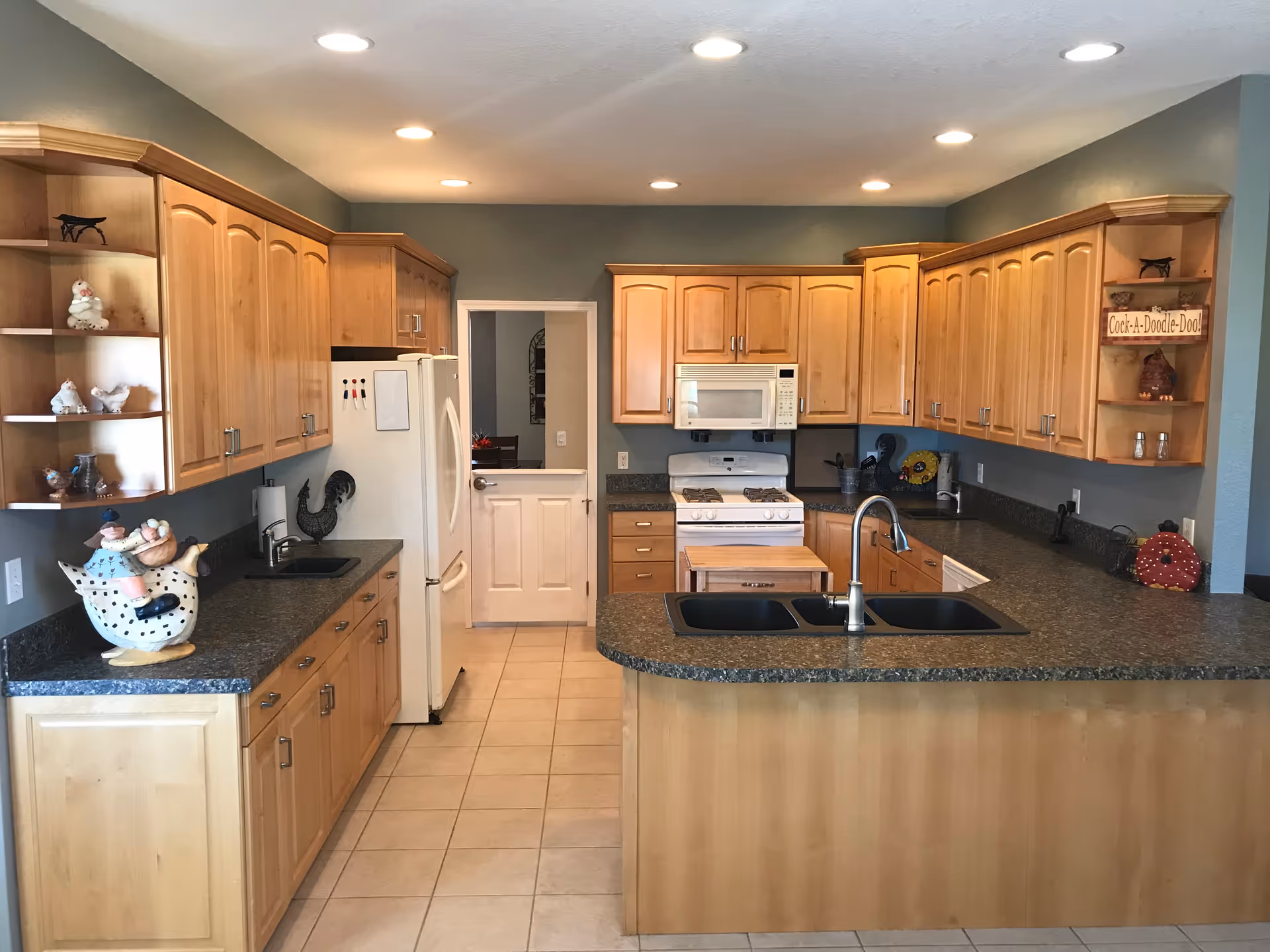 Bright, spacious kitchen with wooden cabinets, island sink, and modern appliances.