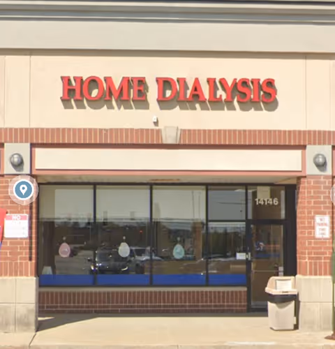 Front view of Home Dialysis storefront with large windows and brick facade.