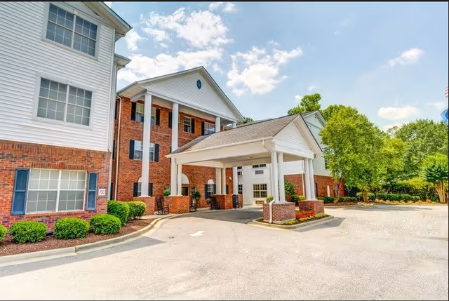 Exterior view of Carolina Gardens at Kathwood entrance with brick building and covered drop-off.
