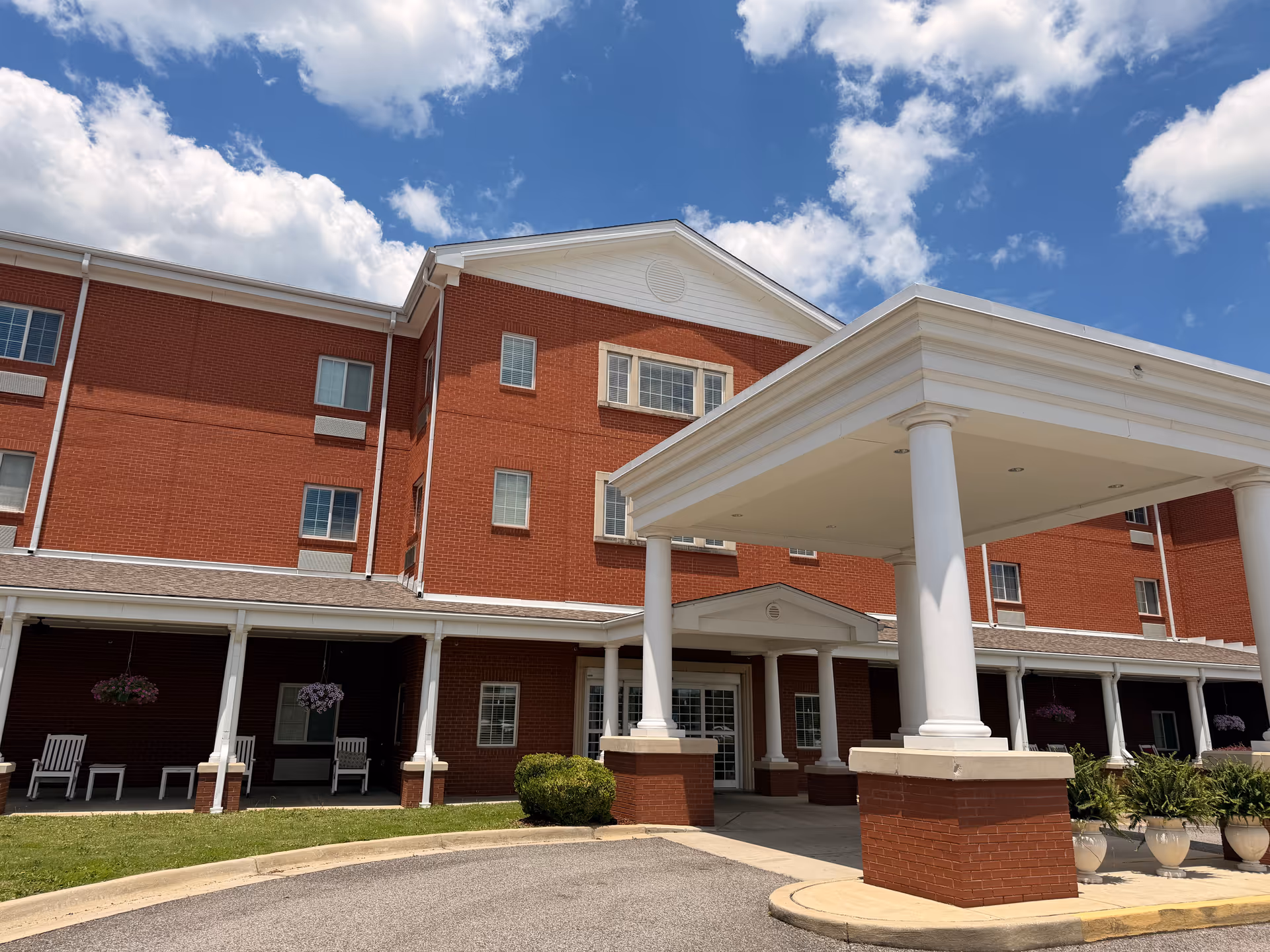 Crimson Village senior living facility exterior with a covered entrance and white columns.