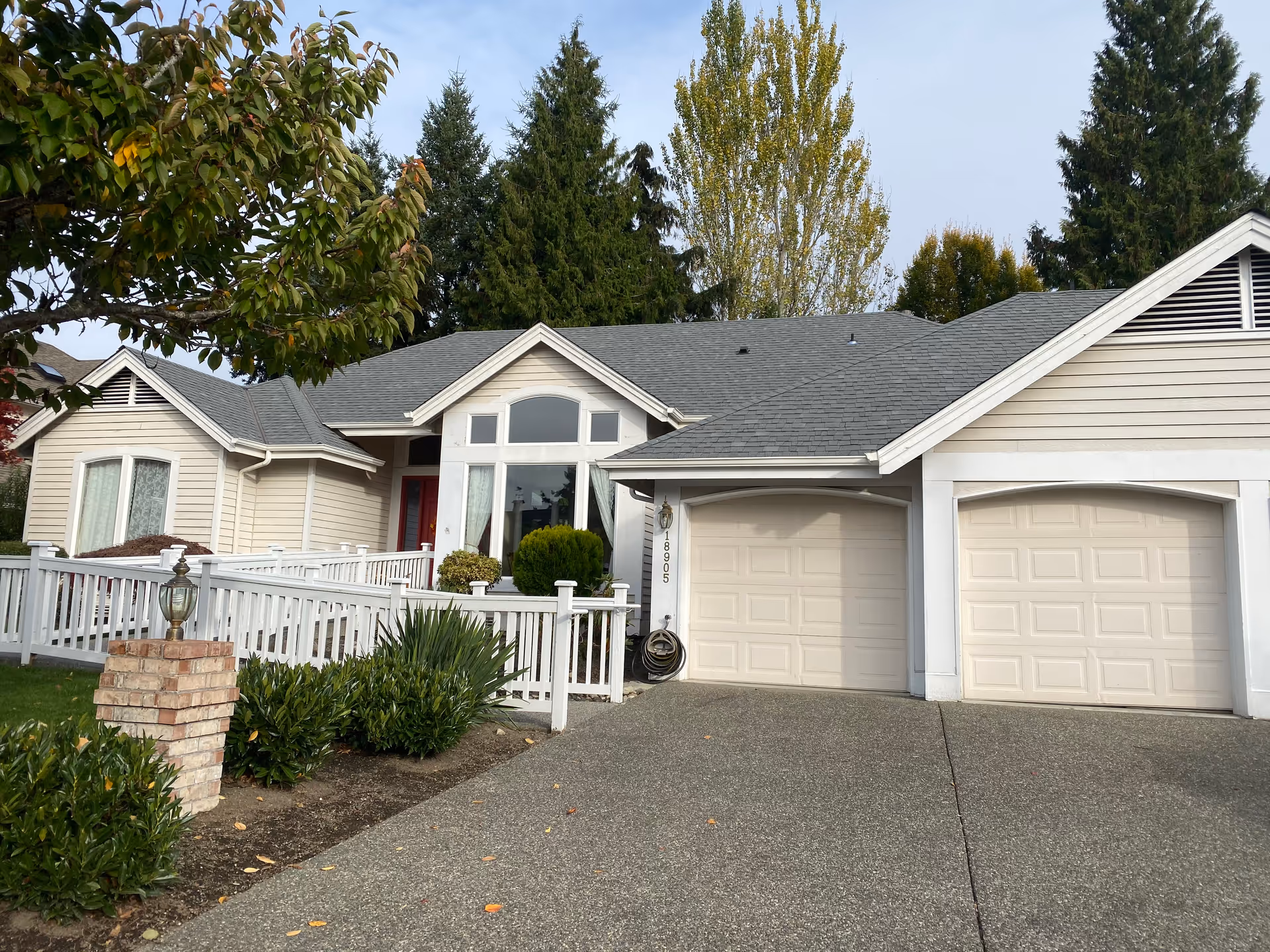 Residential single-story home with attached two-car garage and manicured front yard.