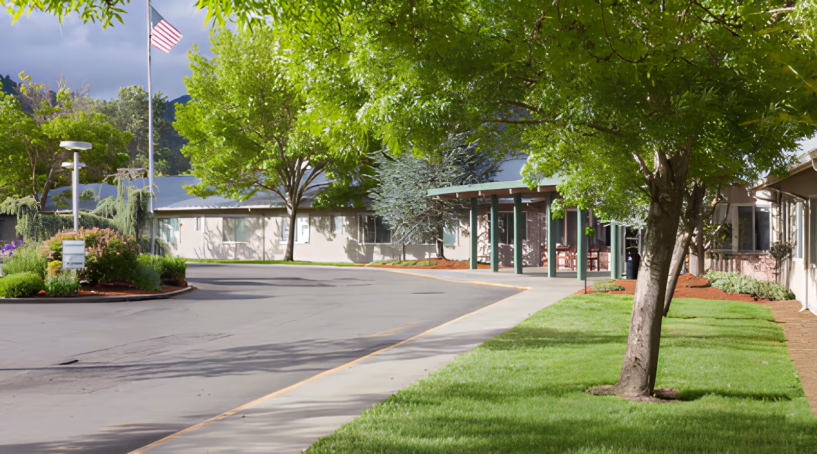 View of the exterior entrance of Royale Gardens Health & Rehabilitation Center surrounded by greenery.