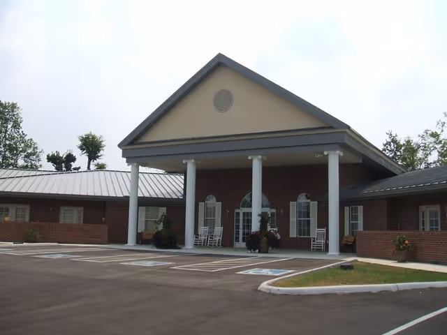 Front exterior of Trousdale Senior Living Center with brick facade and columned entrance.