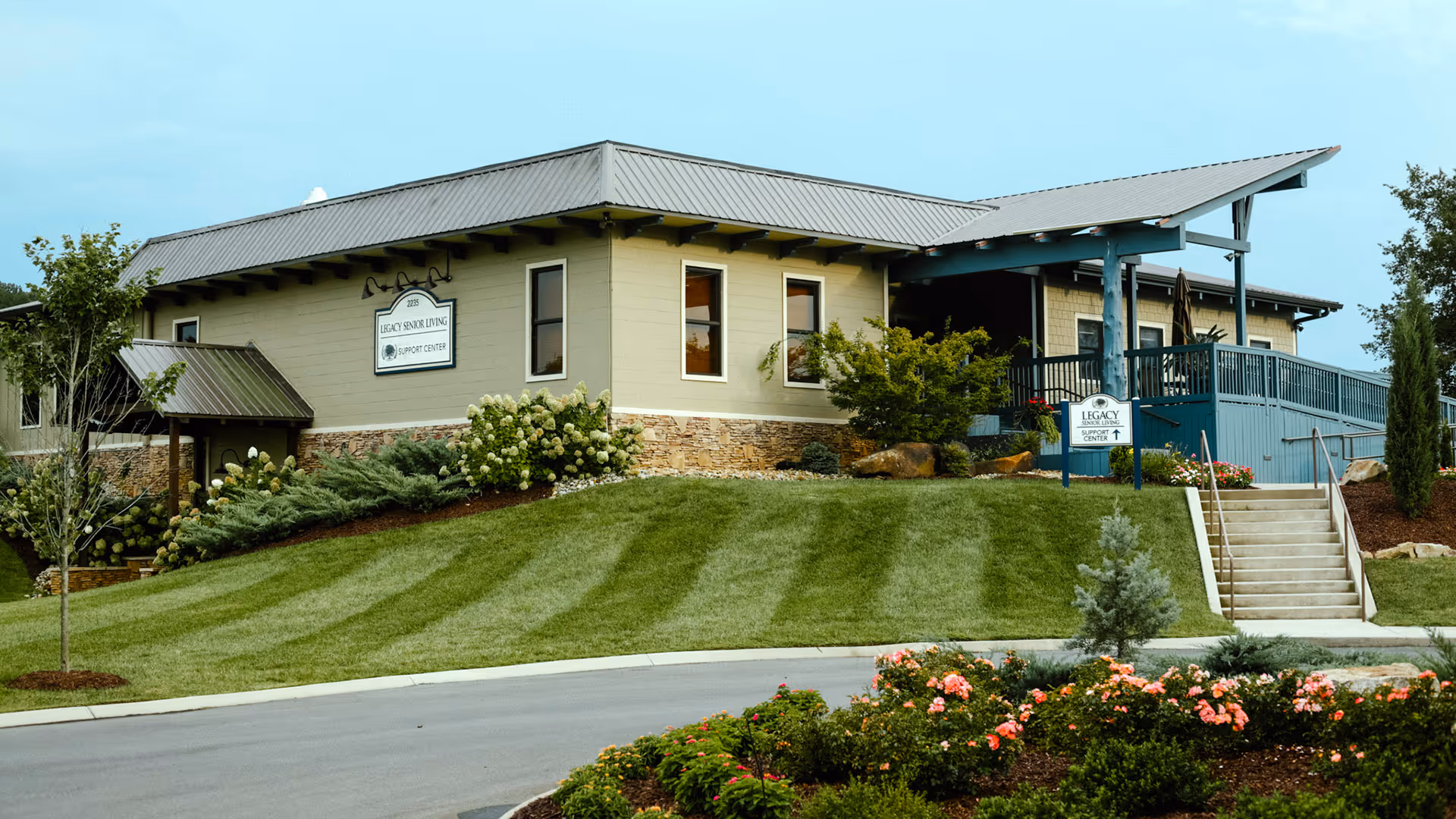 Exterior view of Legacy Senior Living Support Center with landscaped lawn and entrance.