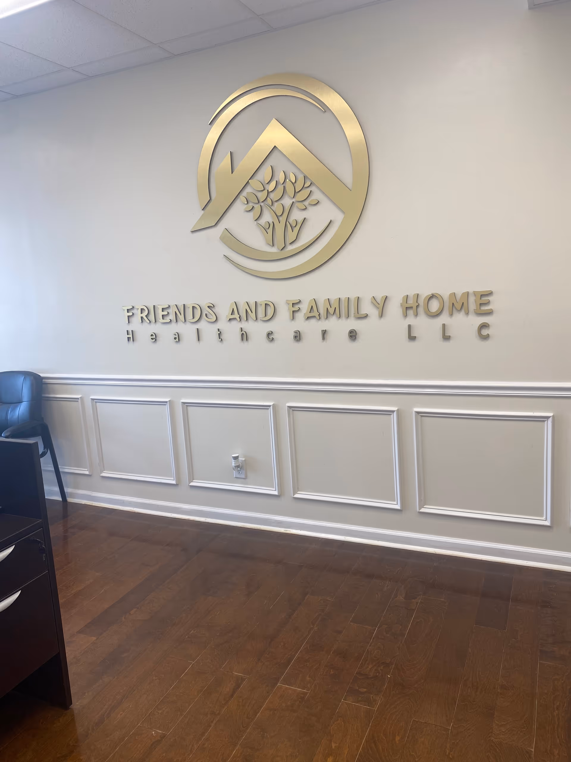 Lobby area with a decorative wall logo and the sign Friends and Family Home Healthcare LLC.