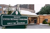 Entrance of a senior care facility with a green sign reading Brooklyn United Methodist Church Home