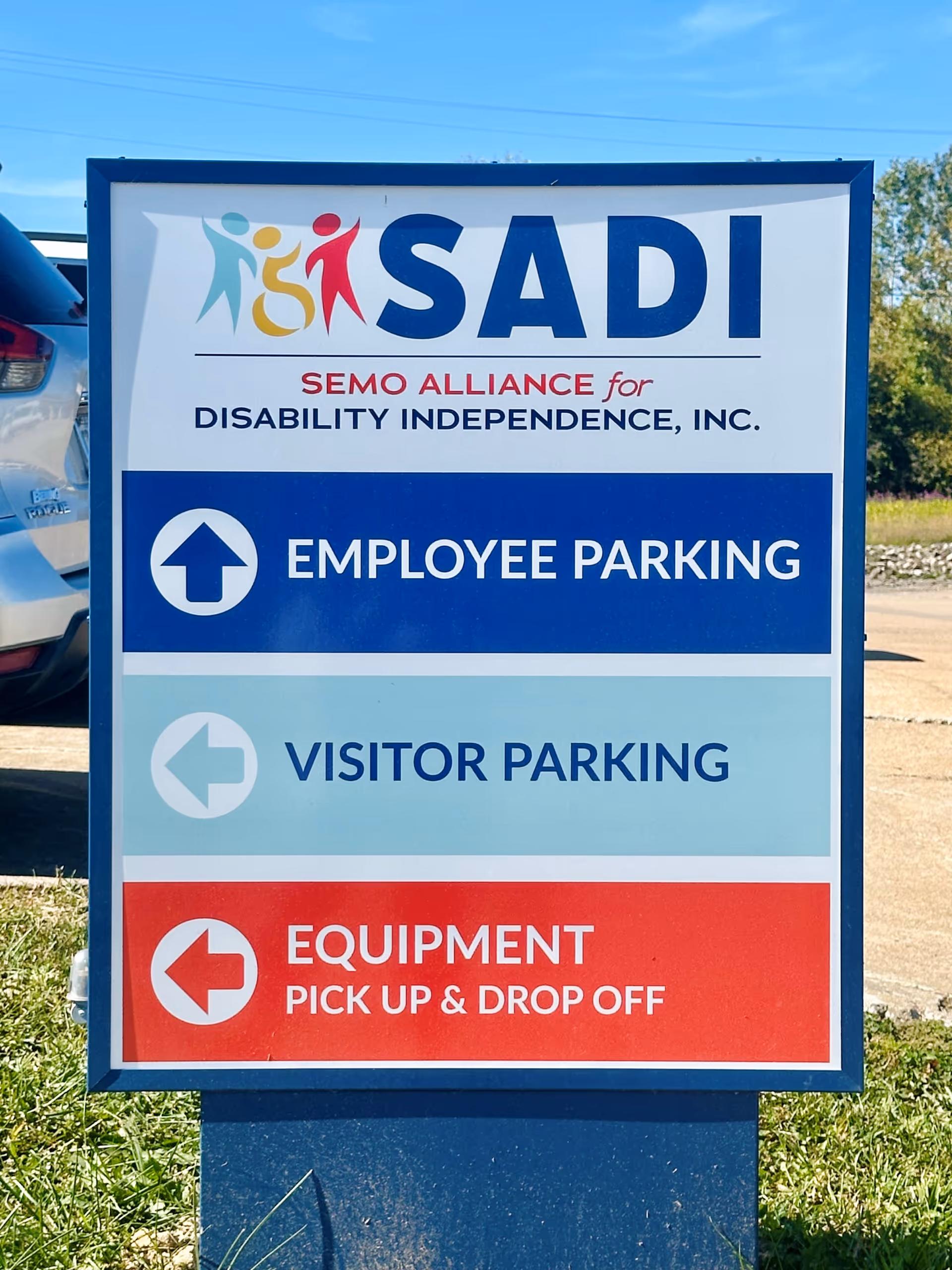 Outdoor SADI sign with employee and visitor parking directions