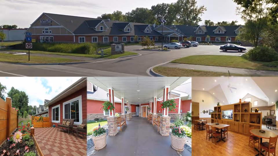 Collage of four images showing White Pine Advanced Assisted Living and Memory Care facility in Fridley. Top image shows the exterior front view of the building with parking lot and surrounding greenery. Bottom left image shows a patio area with seating and flower beds. Bottom middle image shows a covered walkway with benches and hanging flower pots. Bottom right image shows an interior common area with wooden furniture, tables, chairs, and a TV on a wooden divider under a vaulted ceiling.