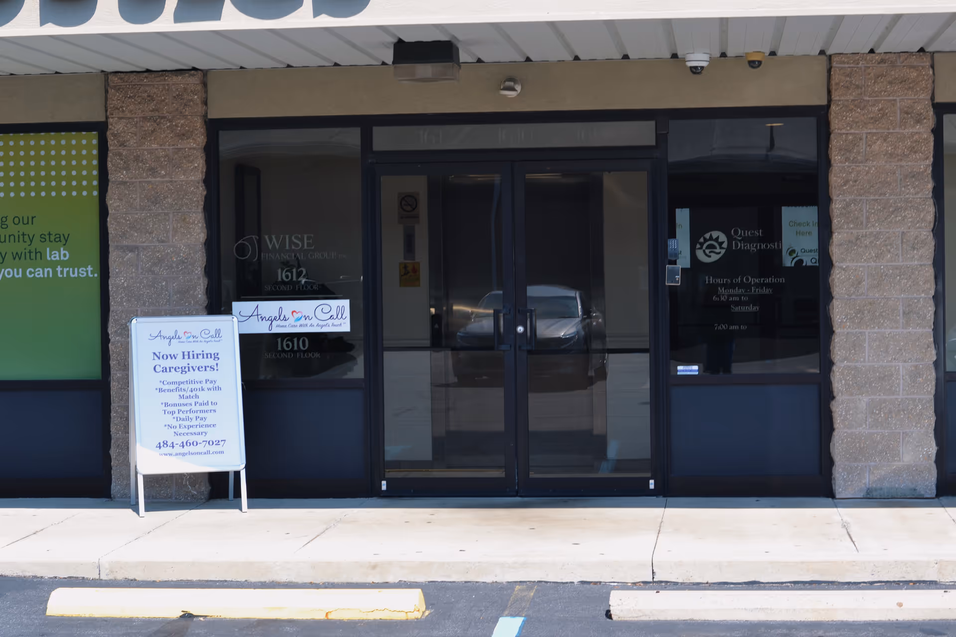 Front of Angels On Call Home Care storefront with glass doors and a hiring sign.