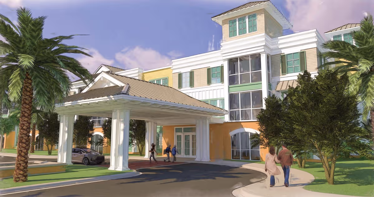 Exterior view of The Arbors of Gulf Breeze featuring a porte-cochere entrance and palm trees.