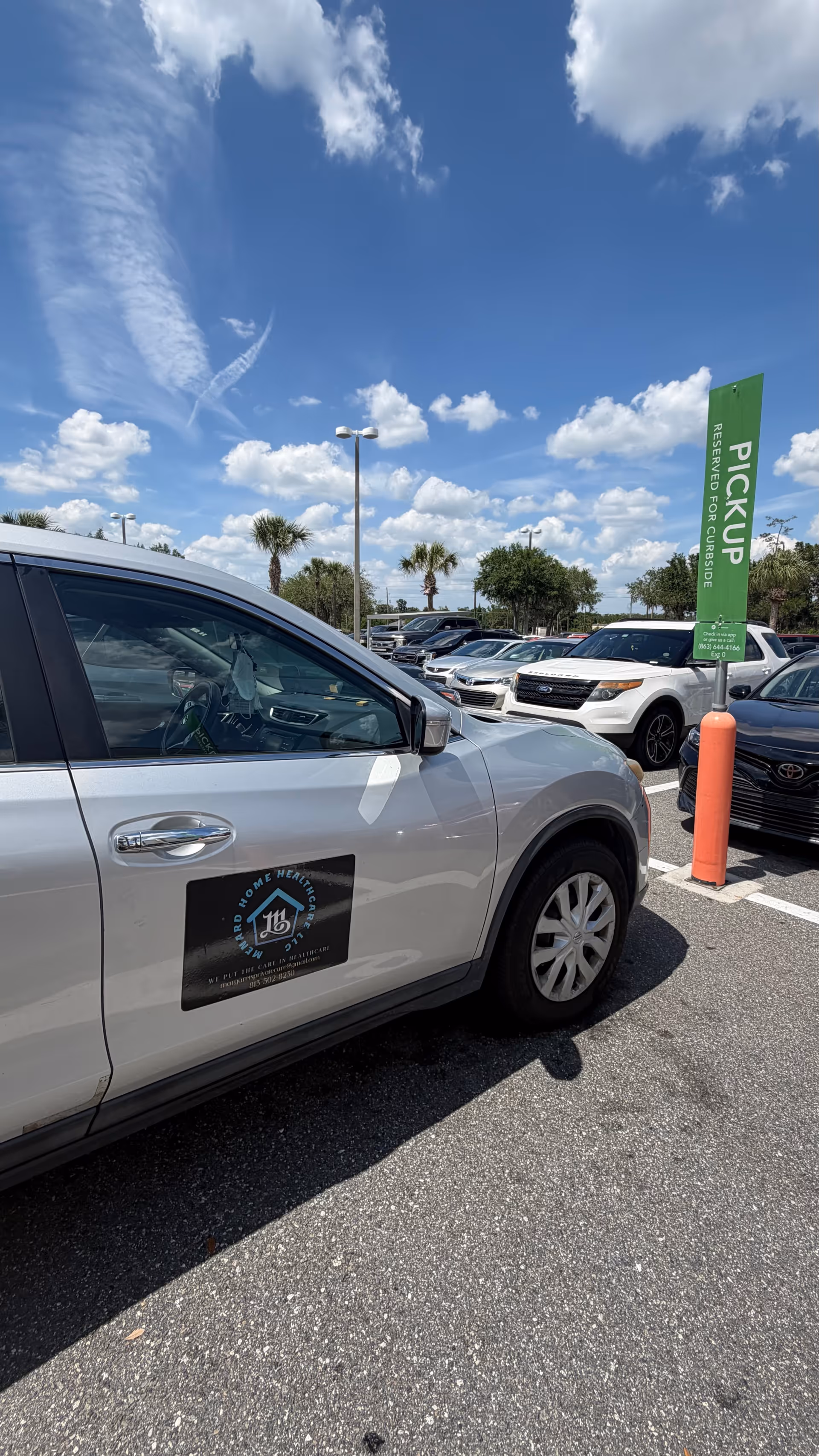 White vehicle with Menard Home Health Care logo parked in a sunny outdoor lot.