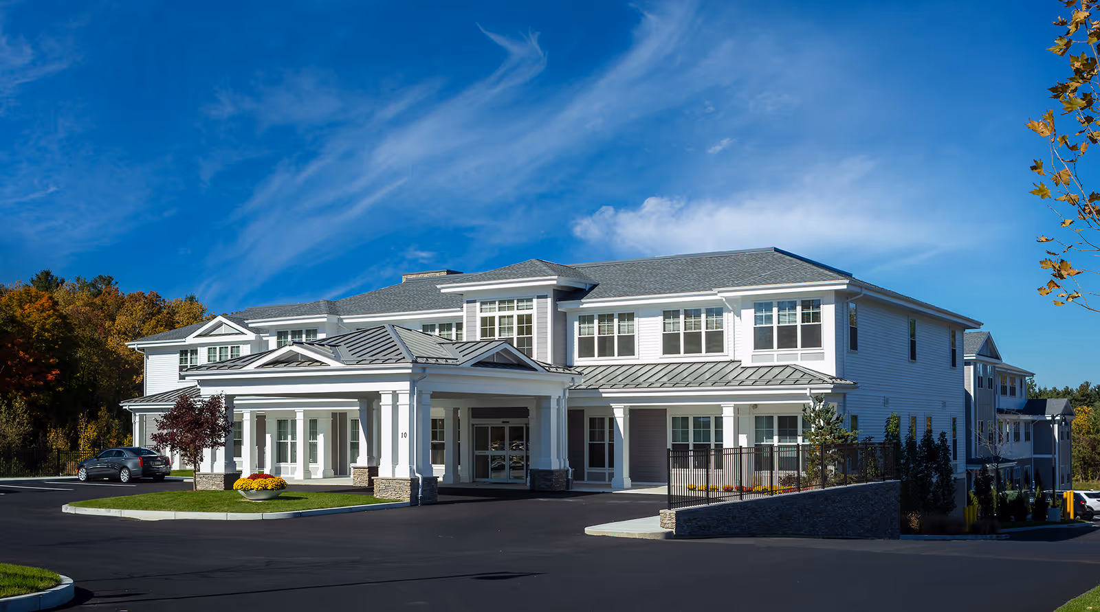 Front exterior view of Wingate Residences at Haverhill, a white two-story senior living facility.