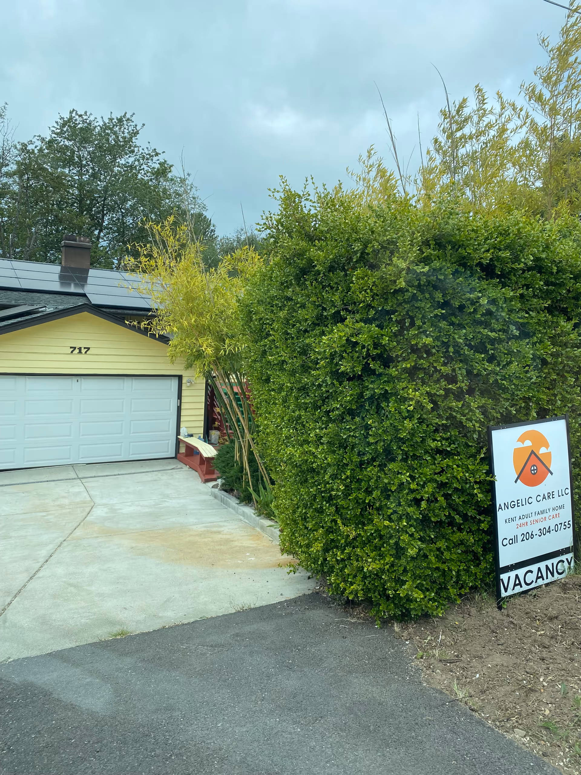 Exterior view of Angelic Care LLC facility with a sign and a garage.