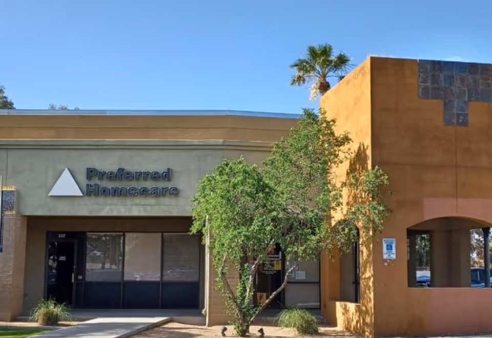 Front view of Preferred Homecare Glendale building with signage and a palm tree