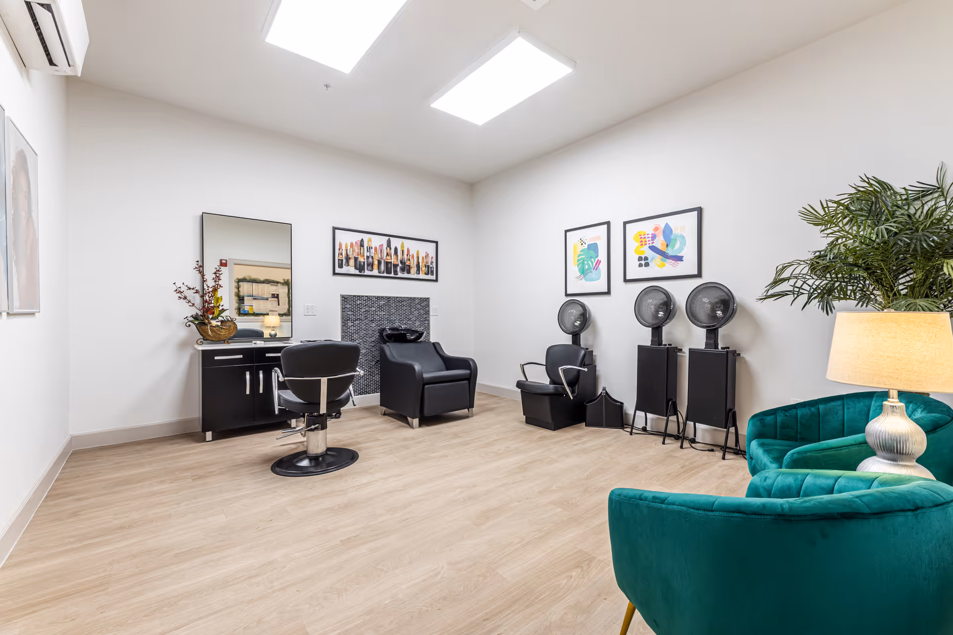Hair salon area with chairs, mirrors, and styling equipment in a bright, modern room.