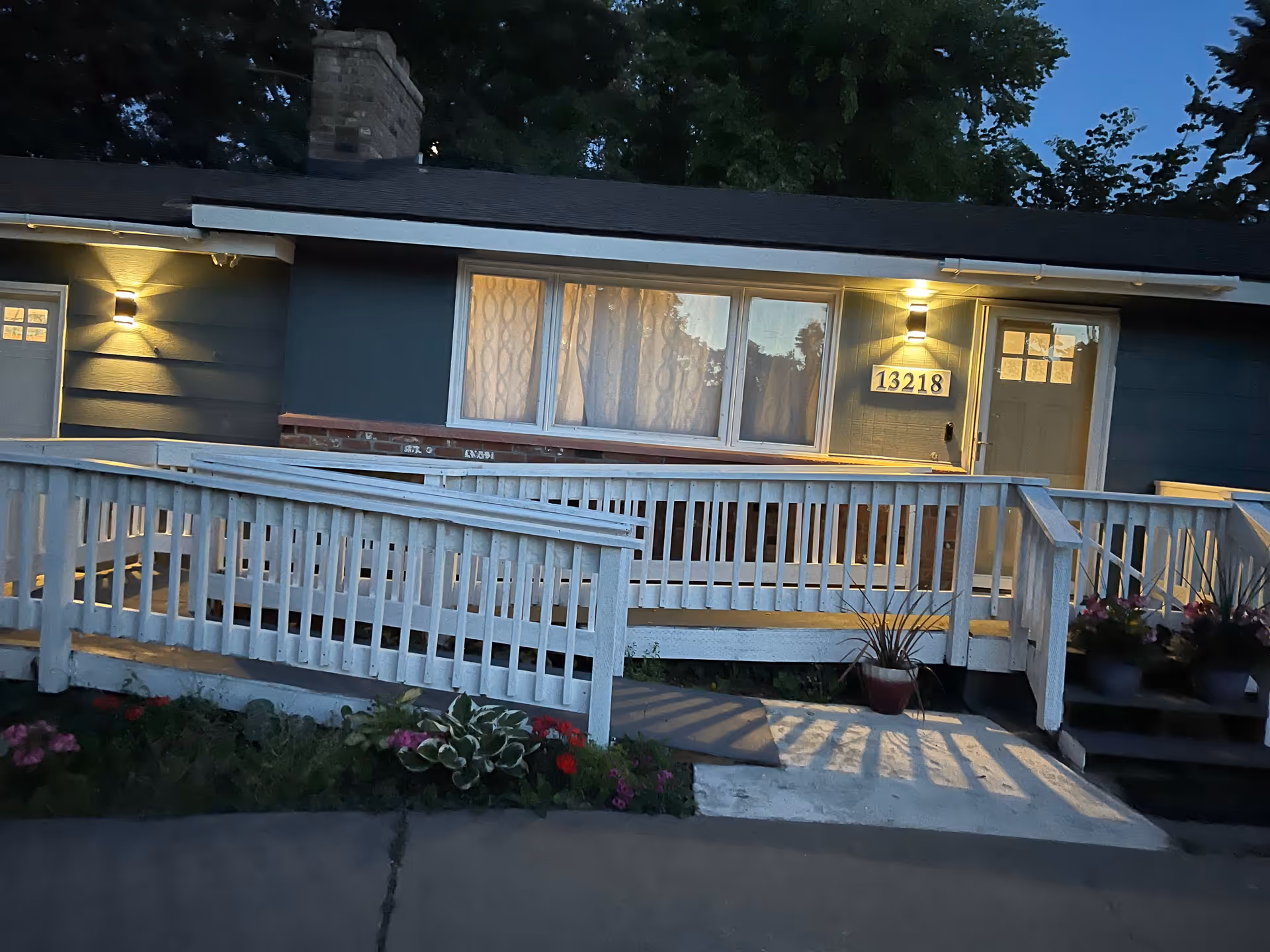 Front exterior of Ayanna Adult Family Home, a single-story blue building with ramp.