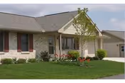 Londonderry Village exterior: a single-story building with front entrance, green lawn, and landscaping.