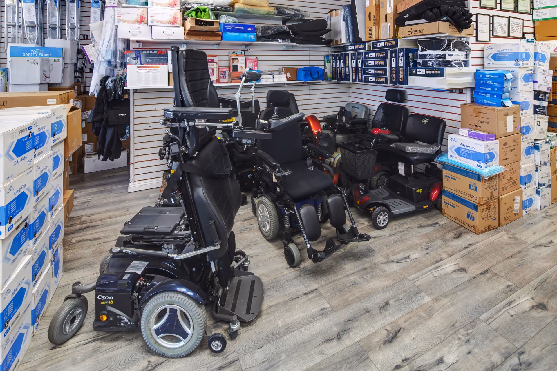 Interior of a medical supply store with mobility scooters and boxed equipment.