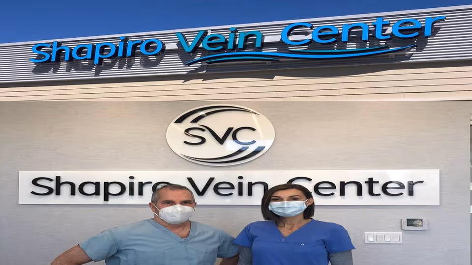 Exterior view of Shapiro Vein Center with two masked medical staff.