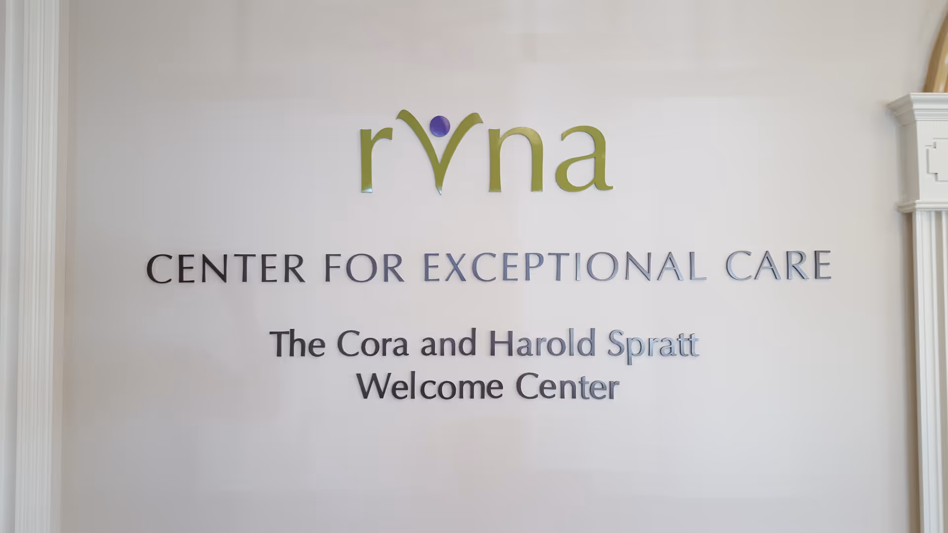 Interior wall displaying RVNA logo and Center for Exceptional Care sign above Welcome Center.