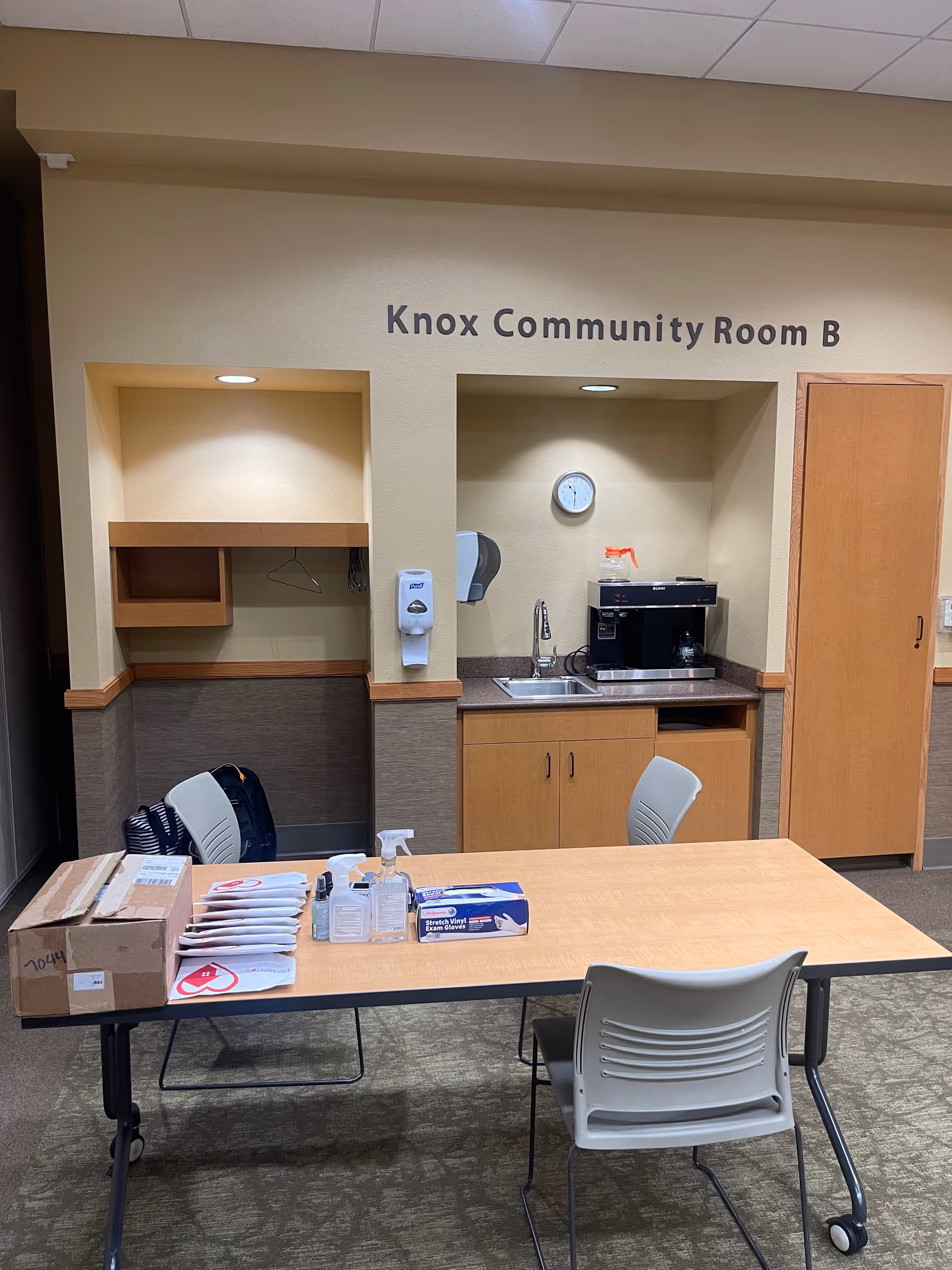 Knox Community Room B interior with table, supplies, and a coffee station.