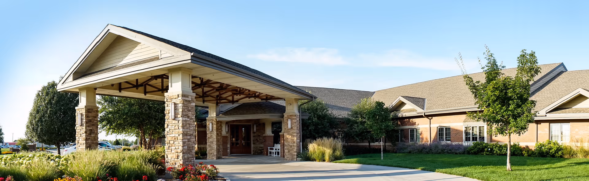 Willow Brook Assisted Living facility exterior with covered entrance, brick walls, and landscaped front yard.