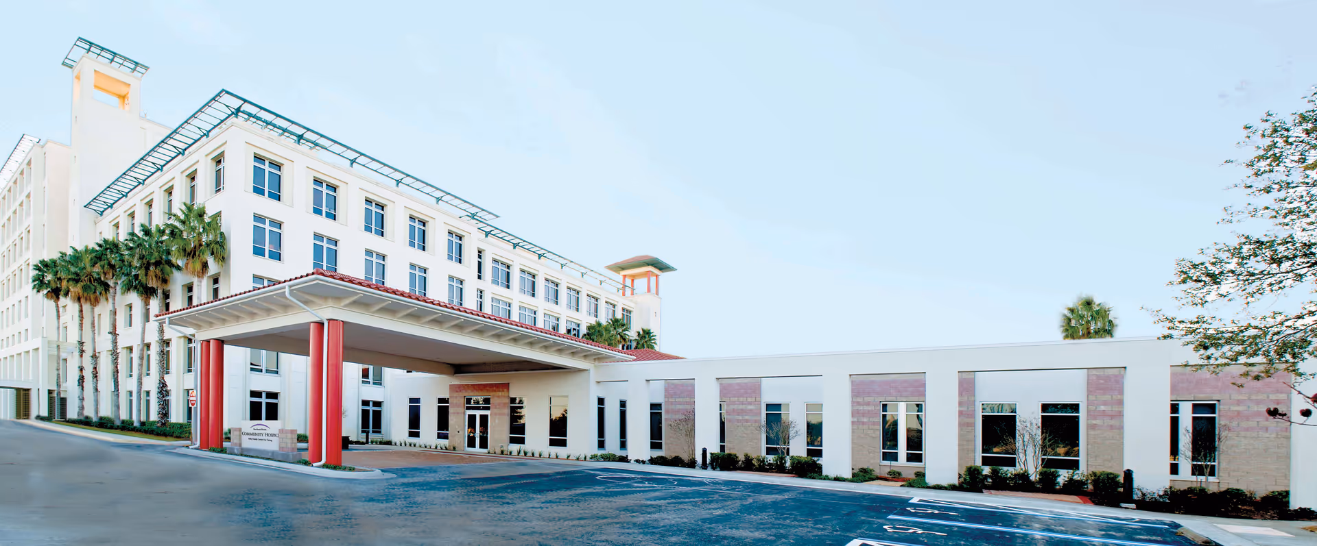 Exterior view of a modern senior living facility with a covered entrance.