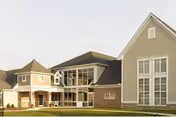Exterior view of St Genevieve Care Center with glass entrance and brick facade.