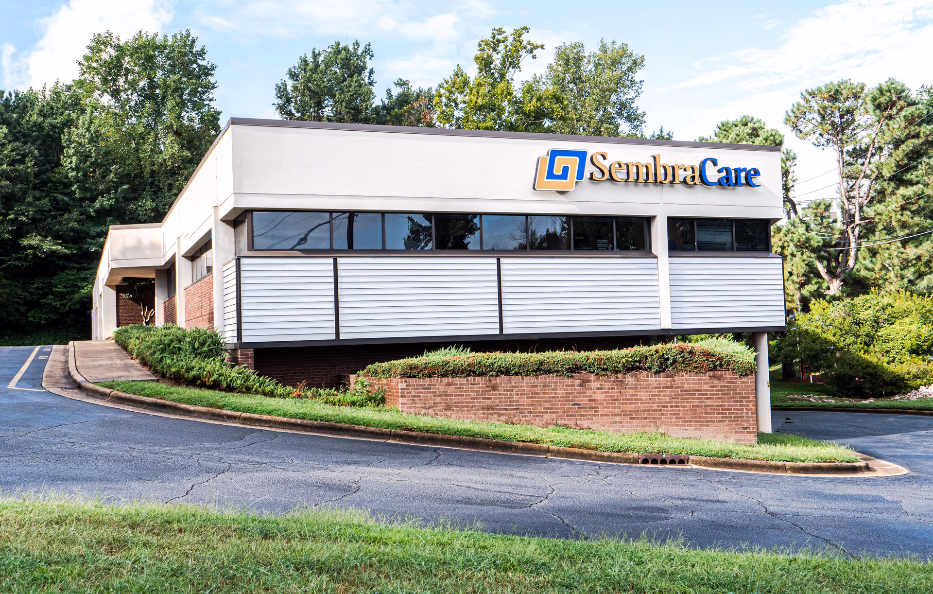 Exterior view of a modern senior care facility with a SembraCare sign.