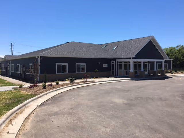Exterior view of BeeHive Homes of Oregon, a single-story building with a curved driveway.
