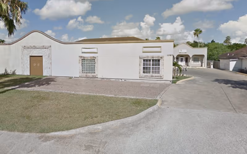 Exterior of VIVE Home and Health Services LLC, a white single-story facility with a curved front.