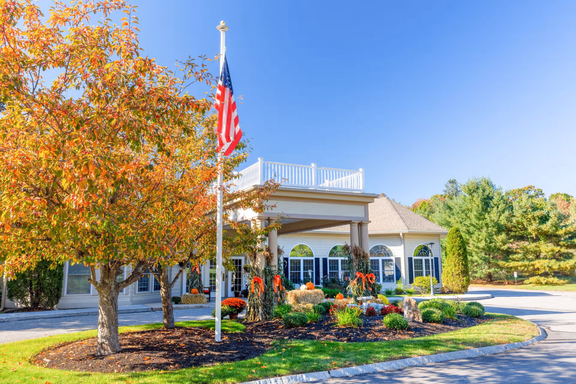 Front view of Benchmark at Haverhill Crossings exterior with flag and landscaped entrance.