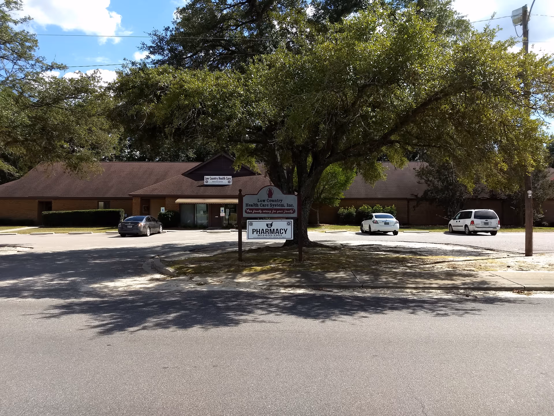 Exterior view of Low Country Health Care System building with parking and trees.