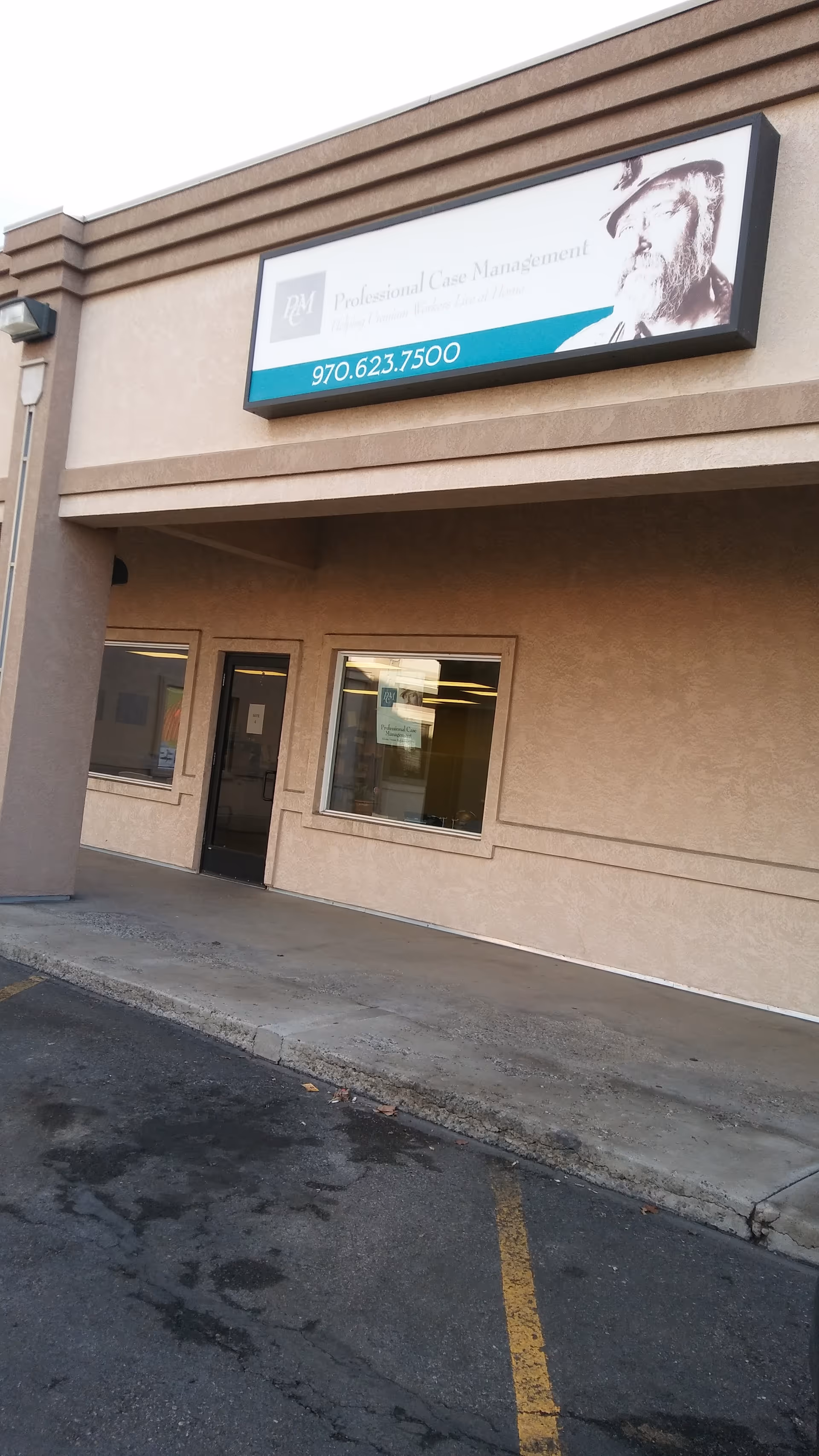 Front view of a beige building with a Professional Case Management sign and entrance.