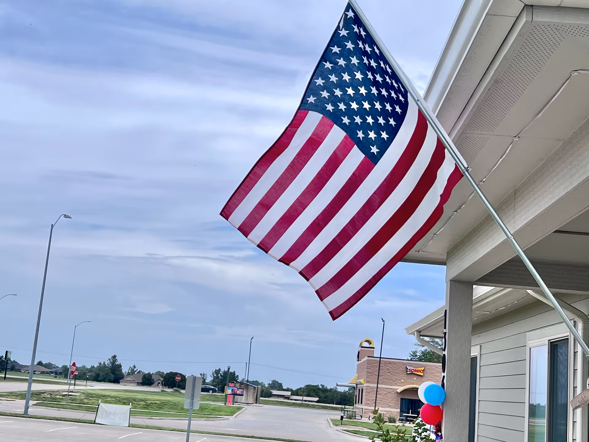 American flag on the exterior of Oakley Place of Seneca with street view