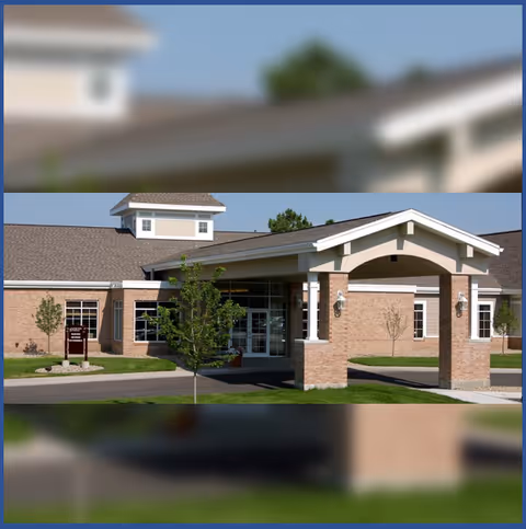 Brick senior living facility exterior with a covered entrance and archway.