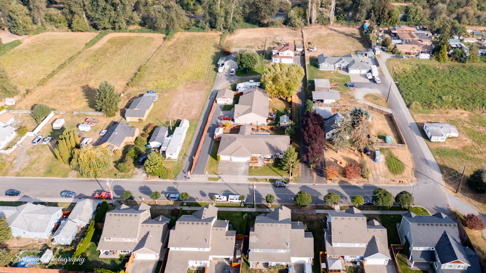Aerial view of a suburban neighborhood with rows of houses and streets.