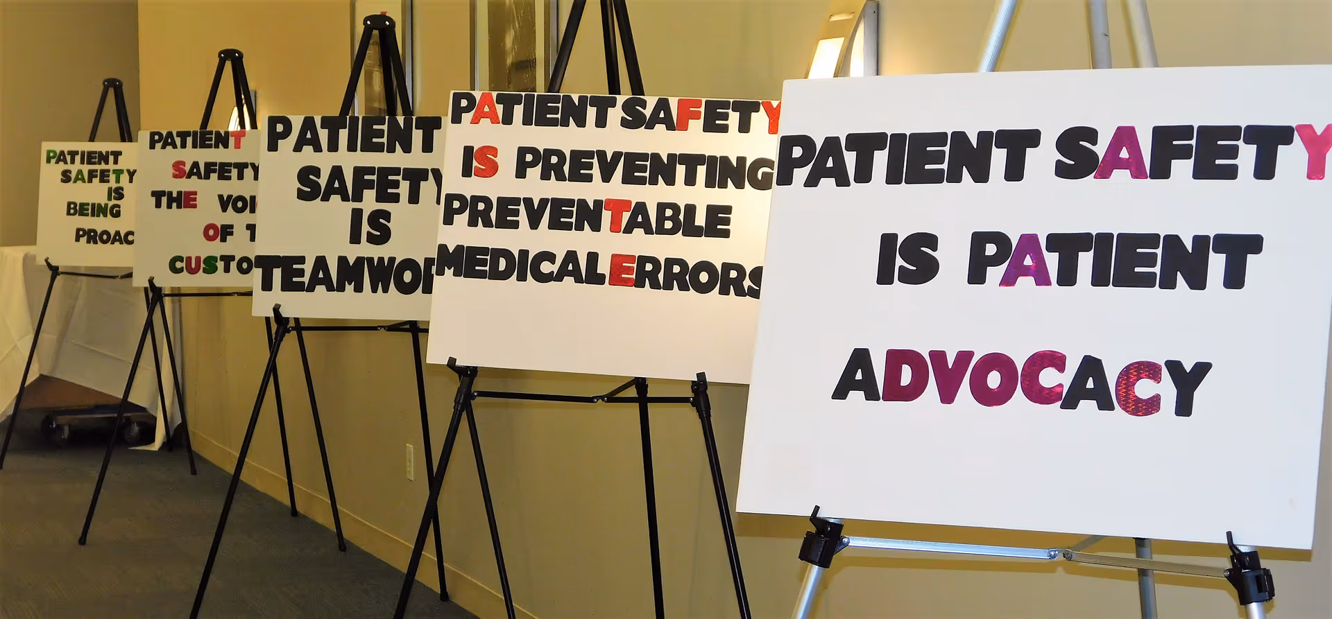 Hallway with multiple large patient safety signs on easels
