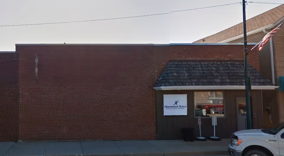 Brick building storefront with Hammond-Henry Hospital Home Health Services sign on exterior wall.